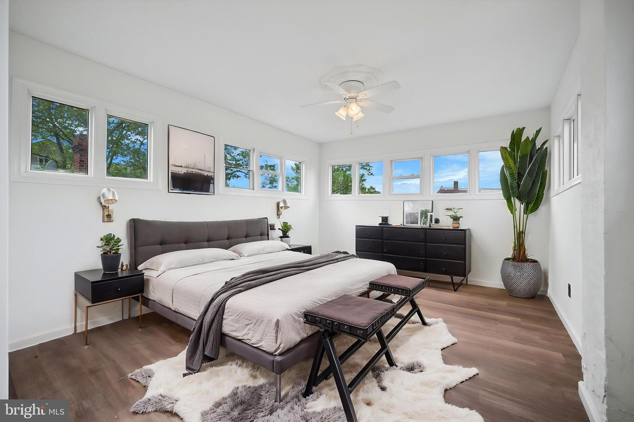 5457 Cedar Avenue Philadelphia, PA 19143 - Photo 15 of 29 a bedroom with a bed table chair and a potted plant