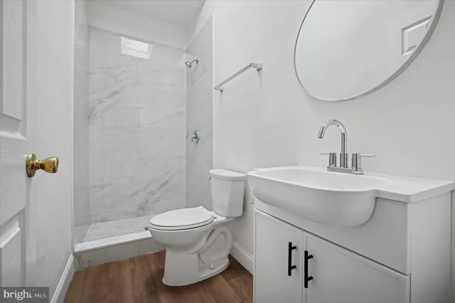 a bathroom with a sink toilet and a mirror