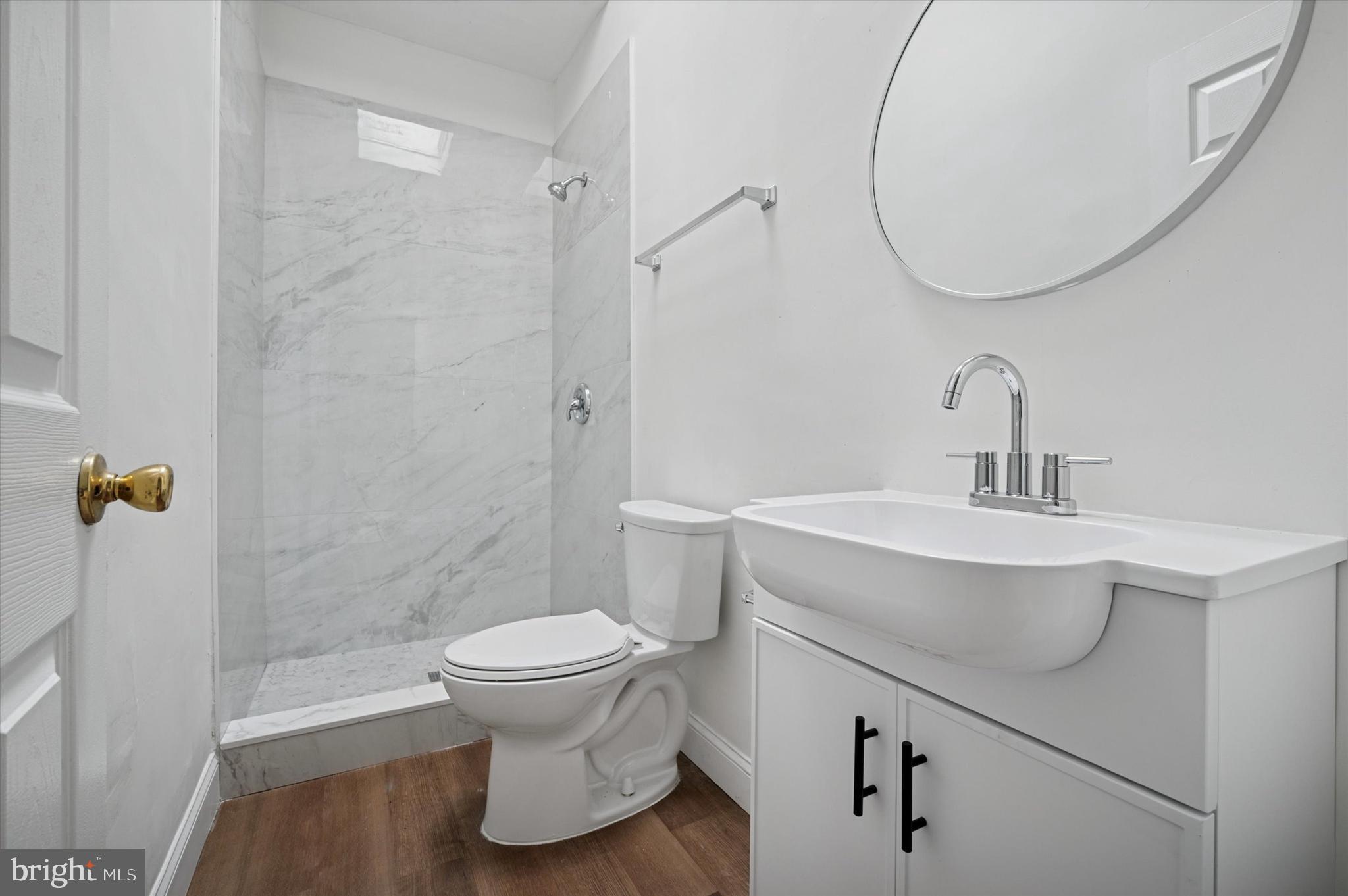 5457 Cedar Avenue Philadelphia, PA 19143 - Photo 16 of 29 a bathroom with a sink toilet and a mirror