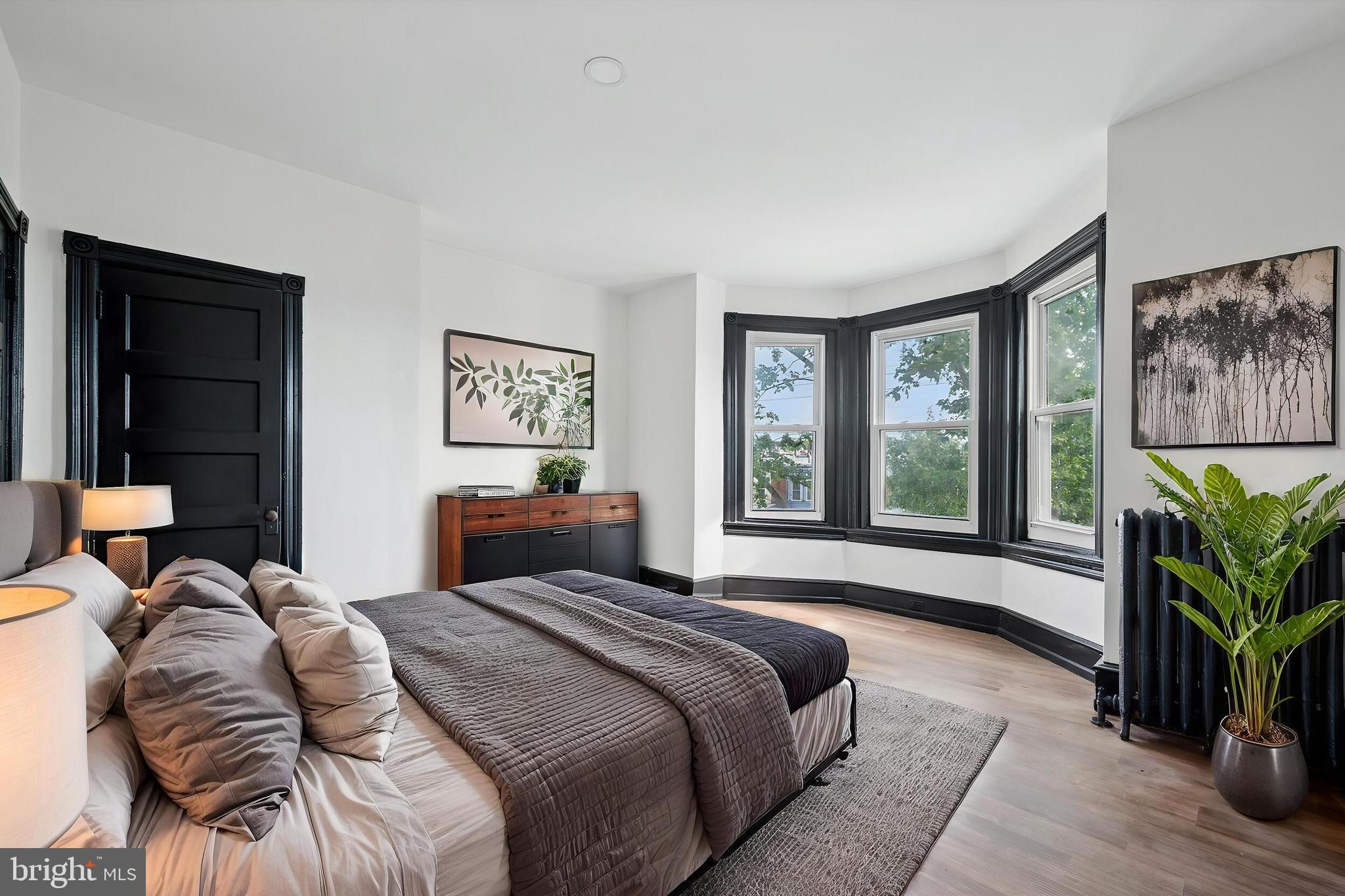 5457 Cedar Avenue Philadelphia, PA 19143 - Photo 18 of 29 a bedroom with a bed and a large window