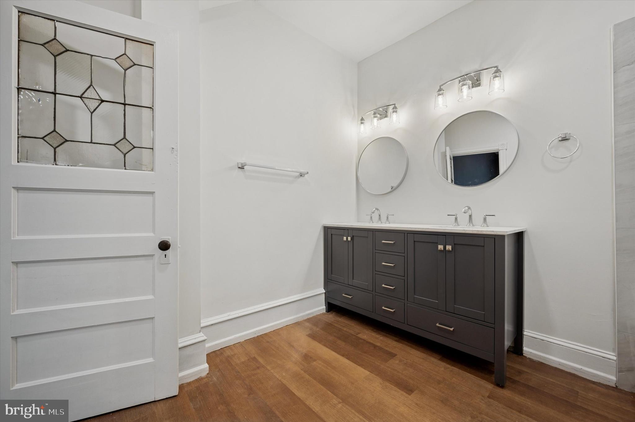5457 Cedar Avenue Philadelphia, PA 19143 - Photo 20 of 29 a bathroom with a sink and a mirror