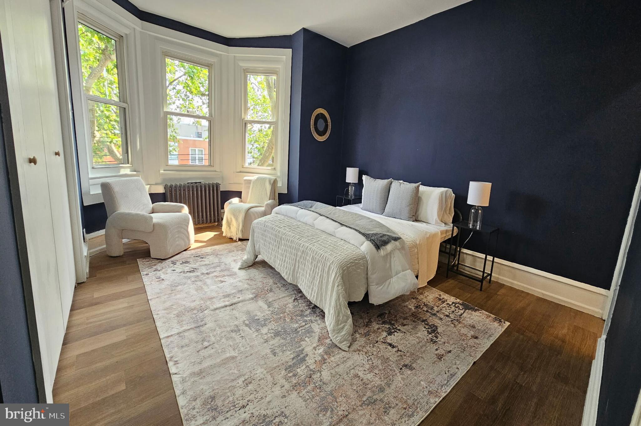 5457 Cedar Avenue Philadelphia, PA 19143 - Photo 21 of 29 a bedroom with a bed and wooden floor