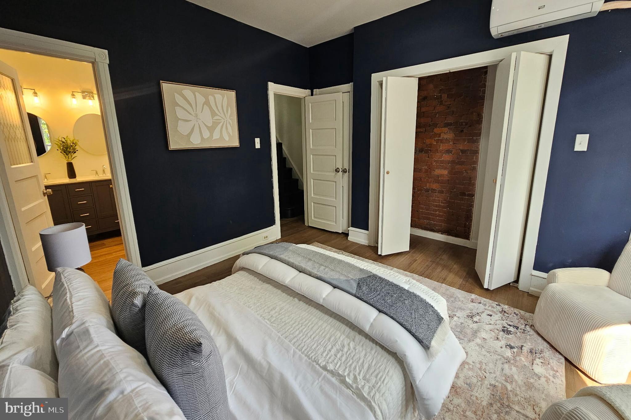 5457 Cedar Avenue Philadelphia, PA 19143 - Photo 22 of 29 a bedroom with a bed and a mirror