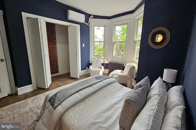 a bedroom with bed and a window