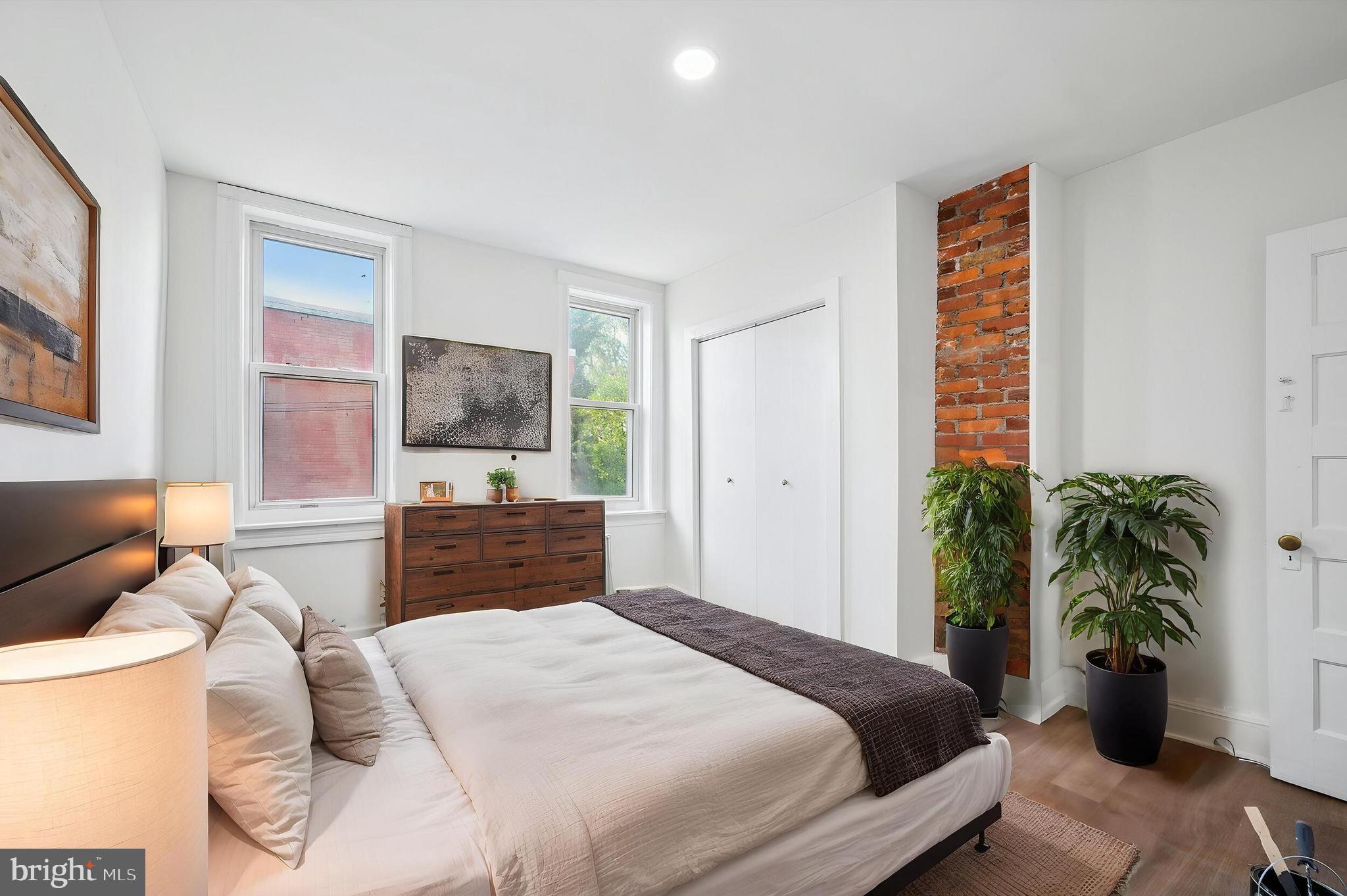 5457 Cedar Avenue Philadelphia, PA 19143 - Photo 25 of 29 a bedroom with a bed and a potted plant