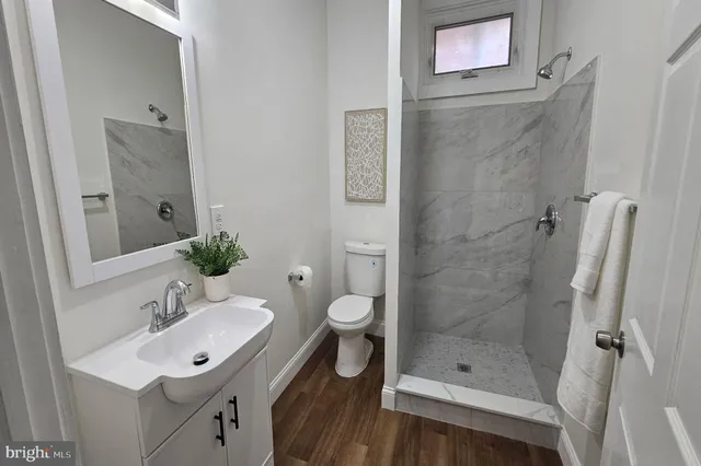 a bathroom with a toilet a sink and shower