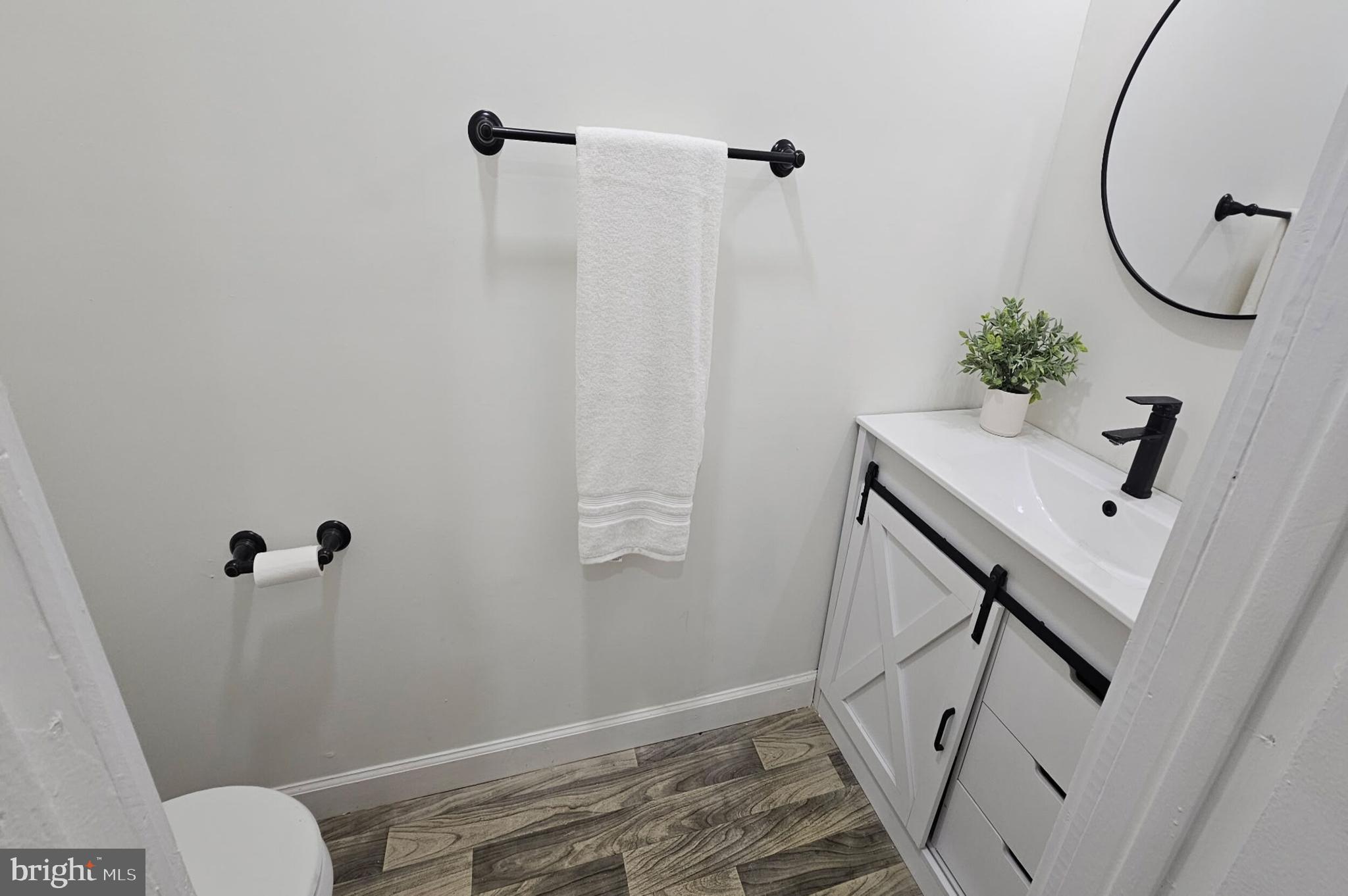 5457 Cedar Avenue Philadelphia, PA 19143 - Photo 7 of 29 a bathroom with a sink toilet and a mirror