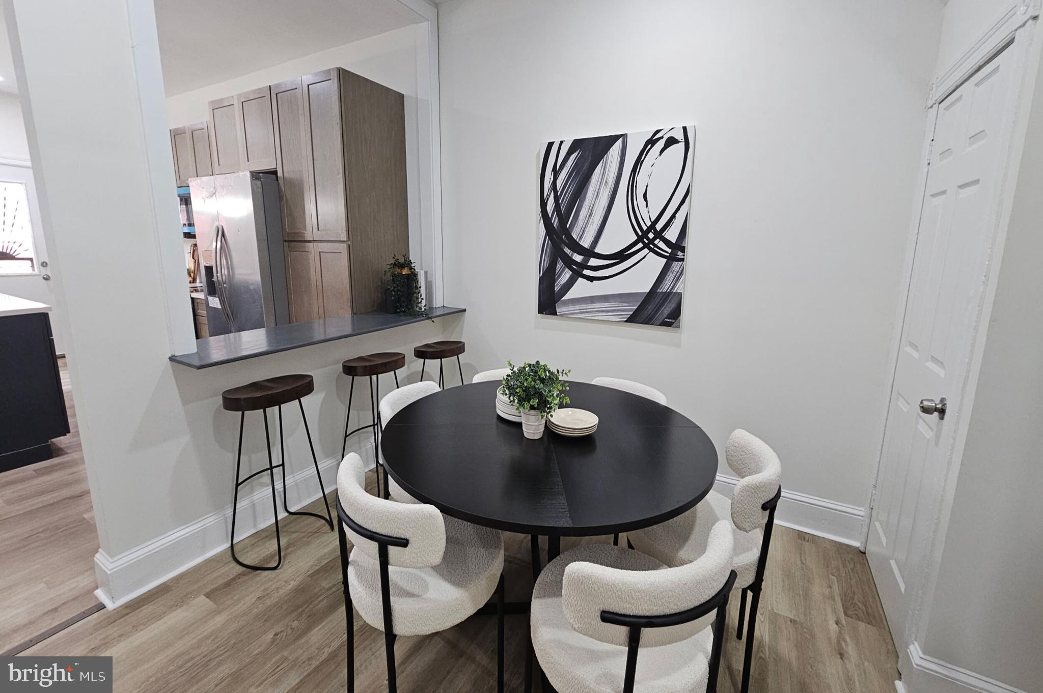 5457 Cedar Avenue Philadelphia, PA 19143 - Photo 10 of 29 a dining room with furniture and wooden floor