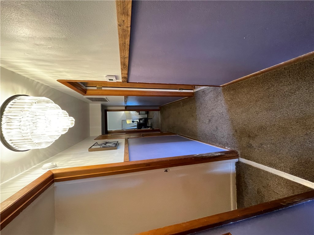 360 Ridge Street Piqua, OH 45356 - Photo 17 of 46 This cozy hallway features soft carpeting and warm lighting, creating an inviting transition between rooms.