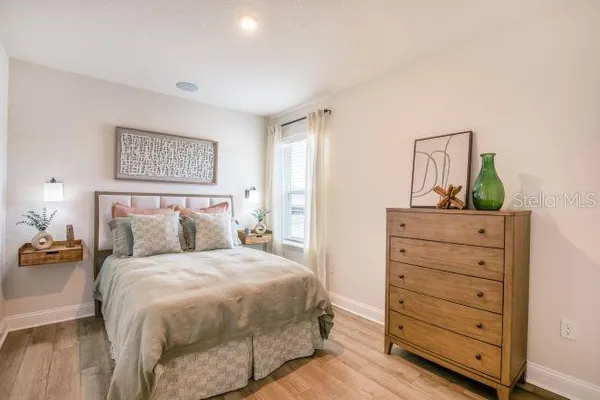 a bedroom with a bed and a dresser