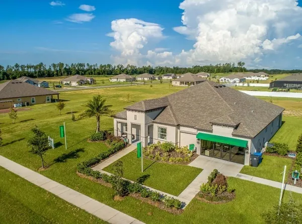 an aerial view of a house with outdoor space and lake view in back