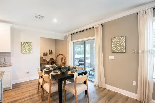 a dining room with furniture and wooden floor