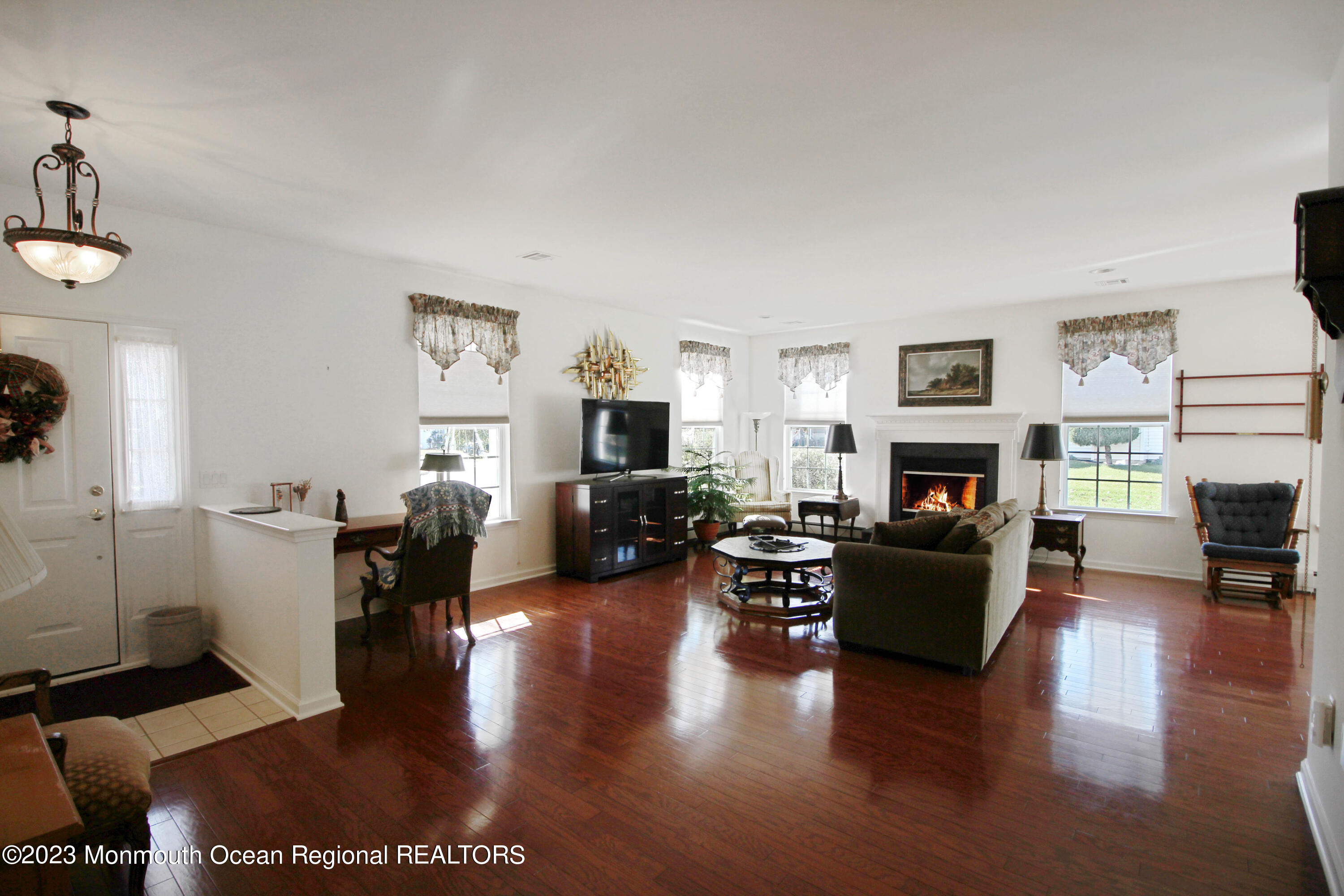 11 Carriage Road Whiting, NJ 08759 - Photo 6 of 35 a living room with furniture a fireplace a flat screen tv and a fireplace