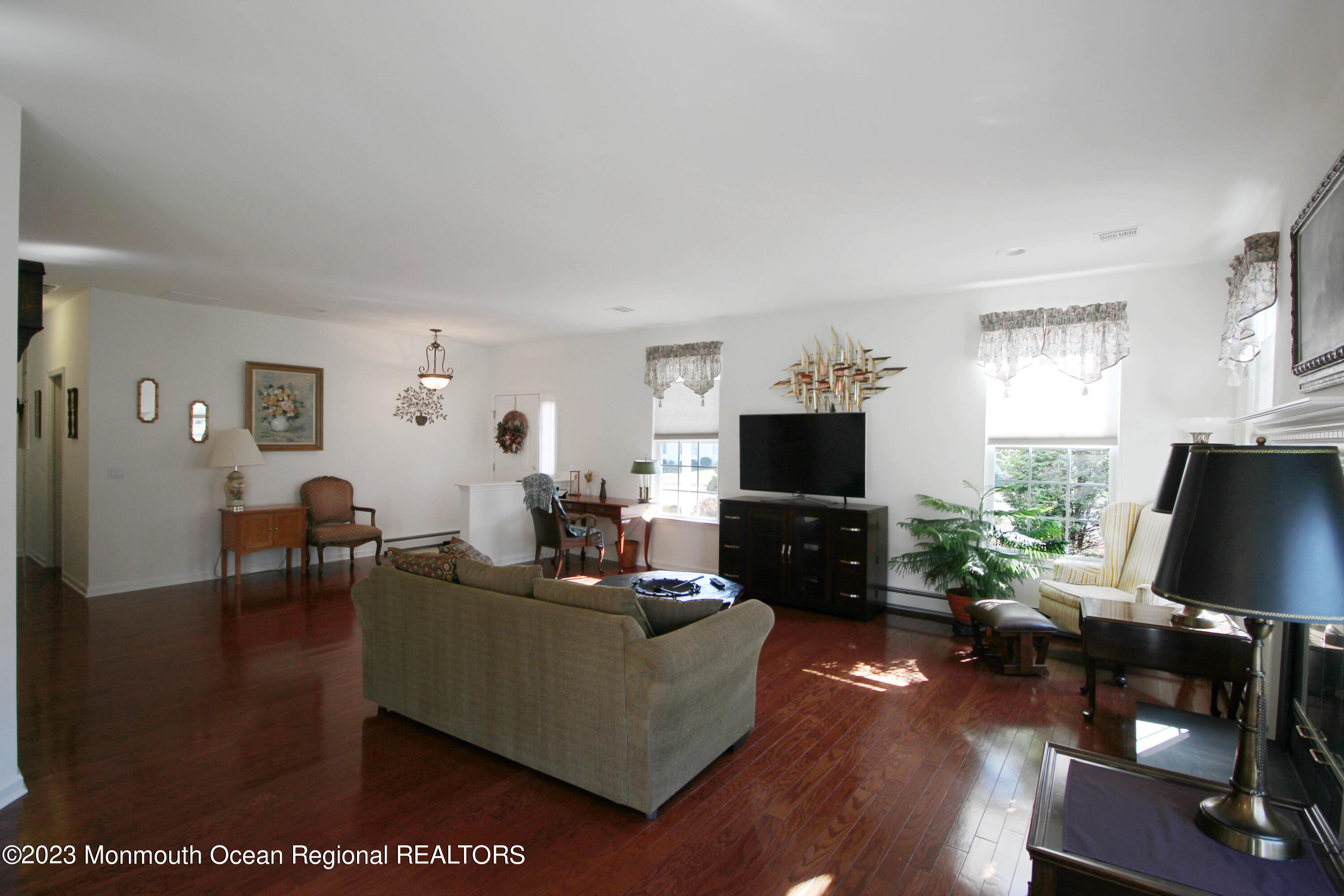 11 Carriage Road Whiting, NJ 08759 - Photo 7 of 35 a living room with furniture a flat screen tv and a fireplace