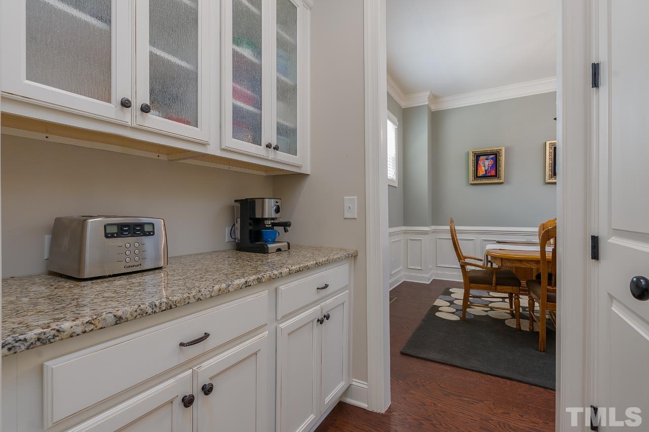4813 Sunset Fairways Drive Apex, NC 27539 - Photo 12 of 44 a kitchen with granite countertop cabinets and chair