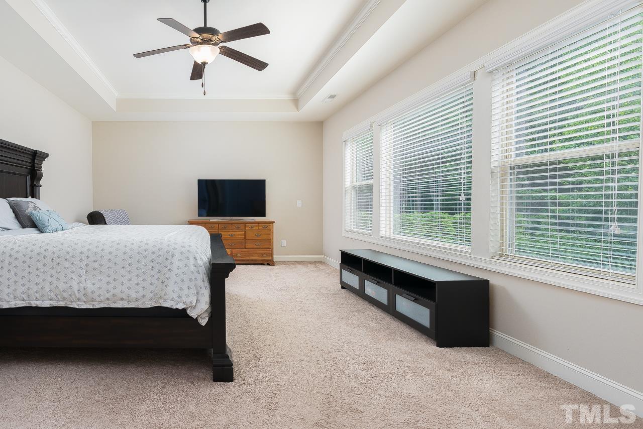4813 Sunset Fairways Drive Apex, NC 27539 - Photo 22 of 44 a spacious bedroom with a bed and a window