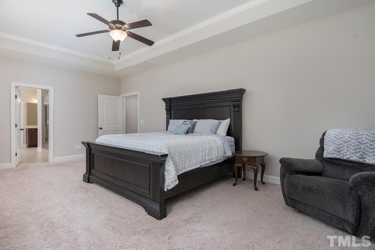 4813 Sunset Fairways Drive Apex, NC 27539 - Photo 23 of 44 a bedroom with a bed couch and window