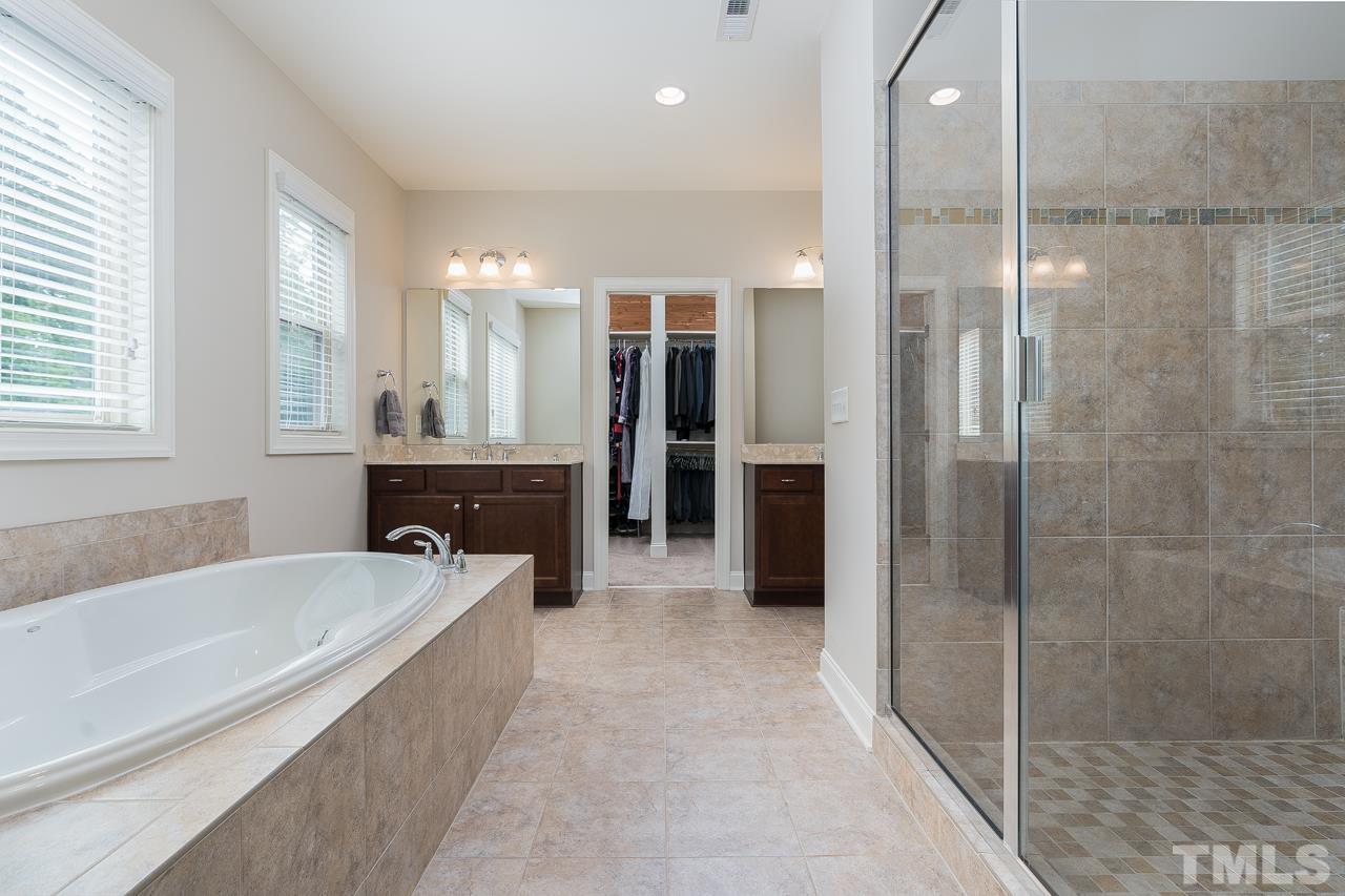 4813 Sunset Fairways Drive Apex, NC 27539 - Photo 24 of 44 a spacious bathroom with a tub shower and sink