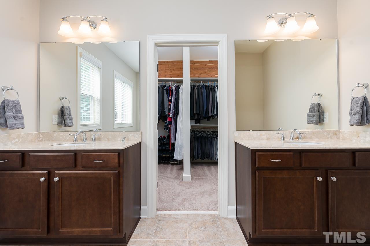 4813 Sunset Fairways Drive Apex, NC 27539 - Photo 26 of 44 a bathroom with a sink a vanity and a mirror