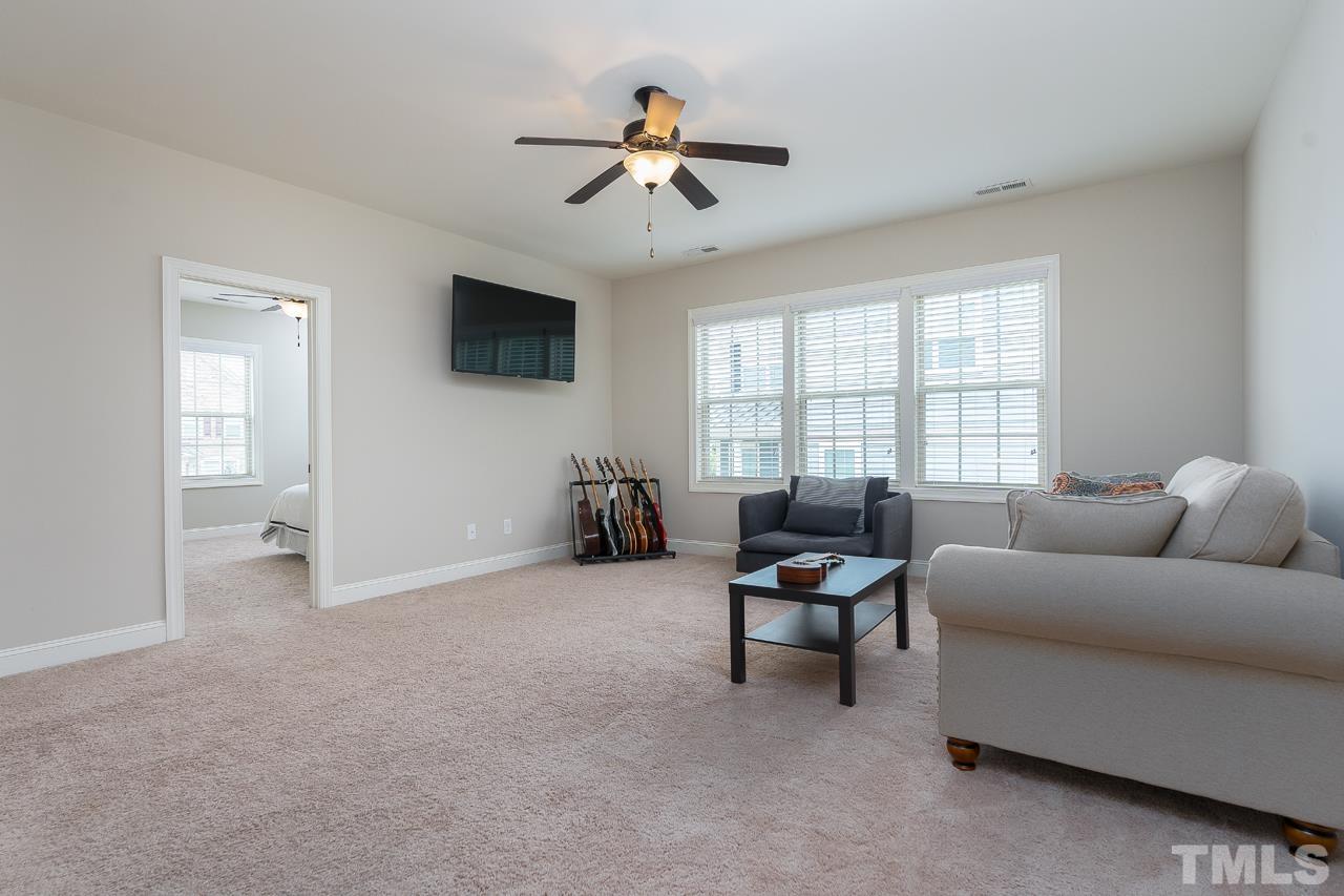 4813 Sunset Fairways Drive Apex, NC 27539 - Photo 27 of 44 a living room with furniture and a ceiling fan