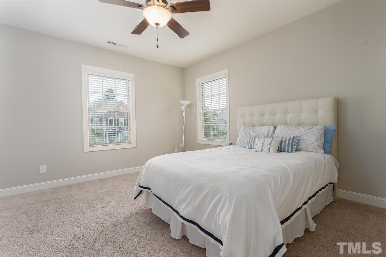 4813 Sunset Fairways Drive Apex, NC 27539 - Photo 28 of 44 a bedroom with a bed and window