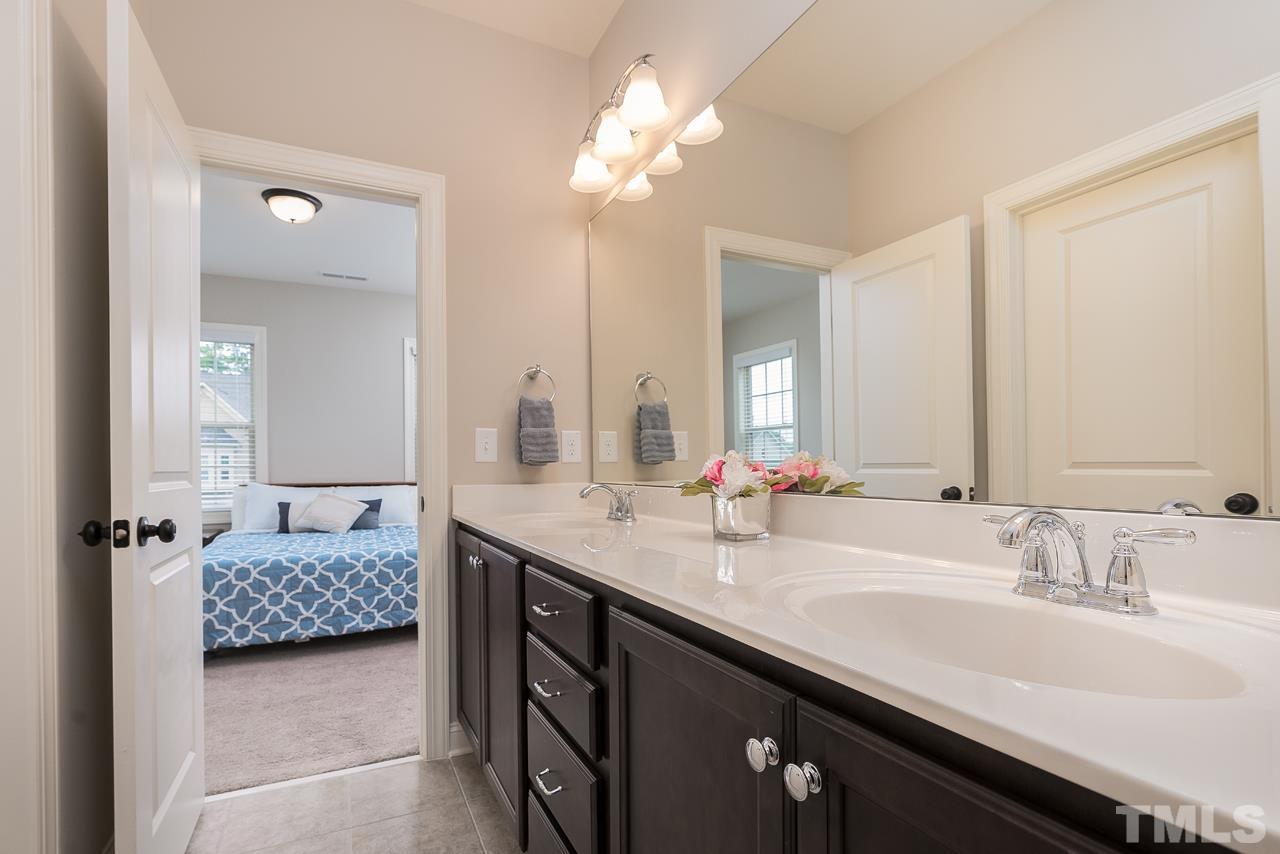 4813 Sunset Fairways Drive Apex, NC 27539 - Photo 33 of 44 a en suite bathroom with a double vanity sink and a mirror