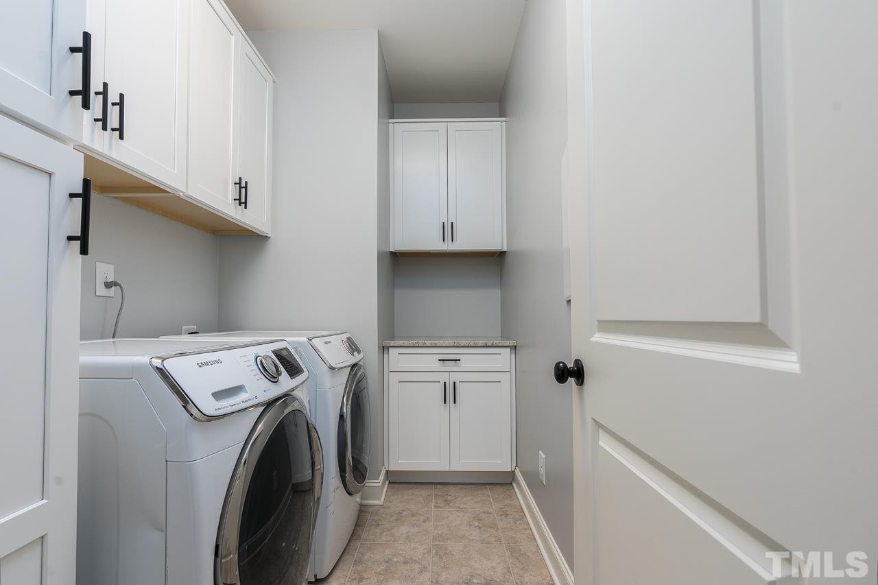 4813 Sunset Fairways Drive Apex, NC 27539 - Photo 36 of 44 a utility room with sink dryer and washer