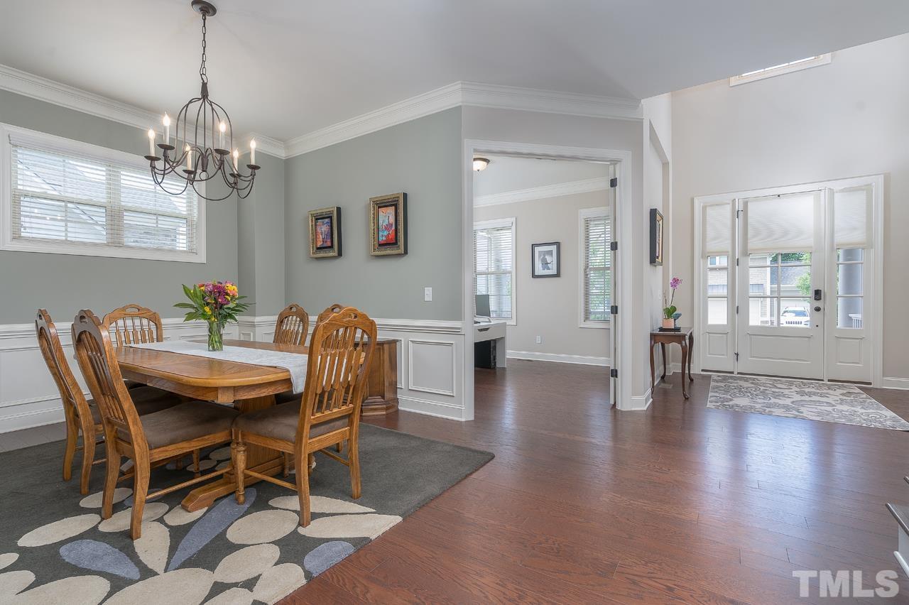 4813 Sunset Fairways Drive Apex, NC 27539 - Photo 10 of 44 a dining room with furniture wooden floor a chandelier and a rug