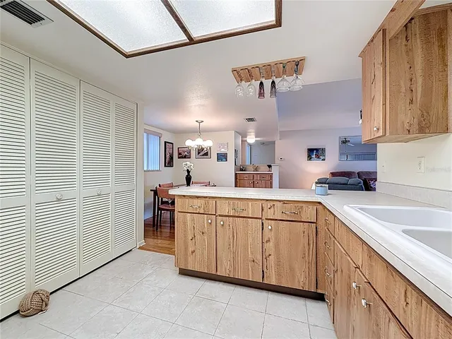 a kitchen with cabinets and window