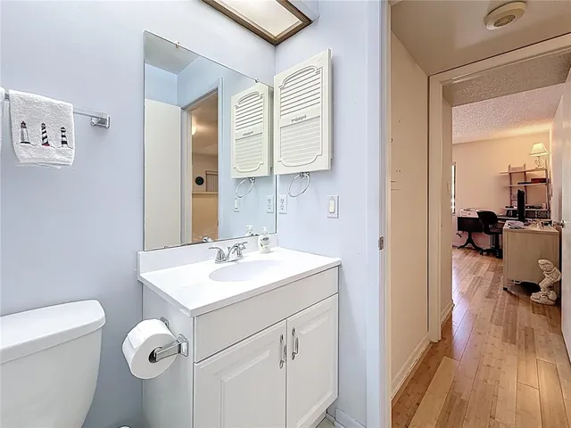 a bathroom with a toilet sink and mirror
