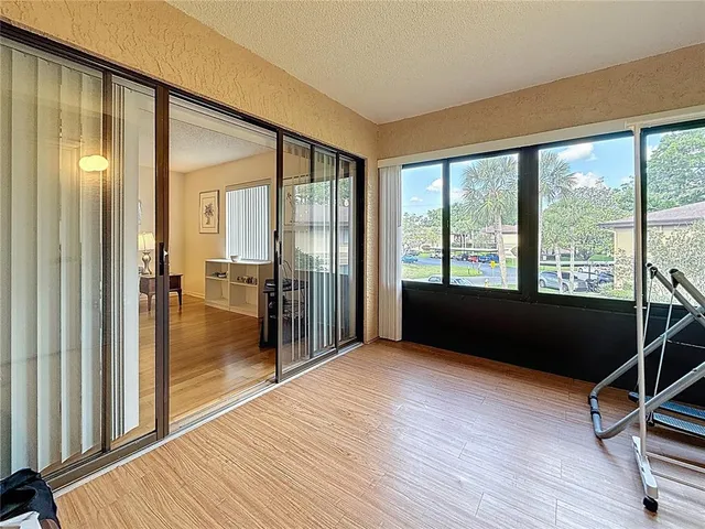 a view of a room with wooden floor and windows