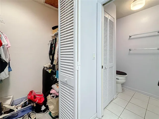 a bathroom with a toilet and a shower curtain