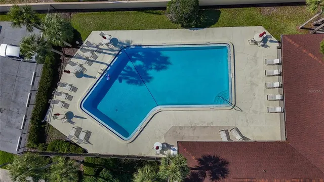 an aerial view of a house with a garden and lake view