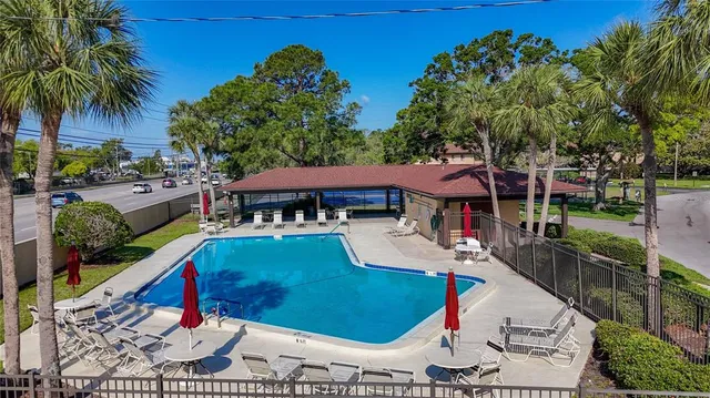 swimming pool view with plants and outdoor seating