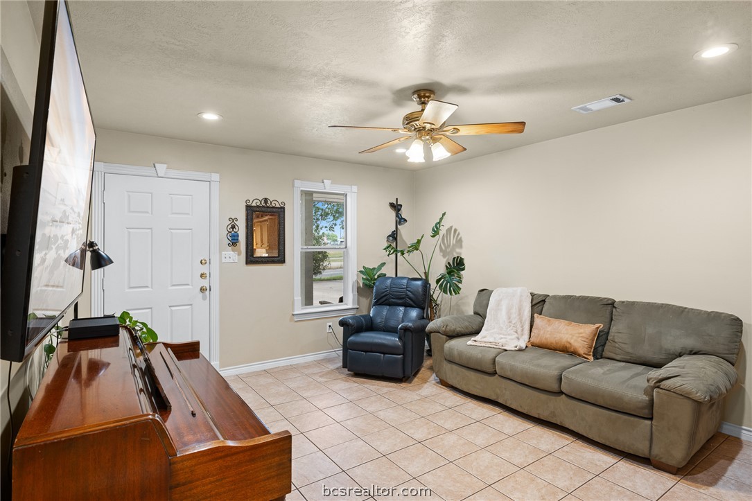 2287 North Earl Rudder Freeway Bryan, TX 77803 - Photo 7 of 32 a living room with furniture and a flat screen tv