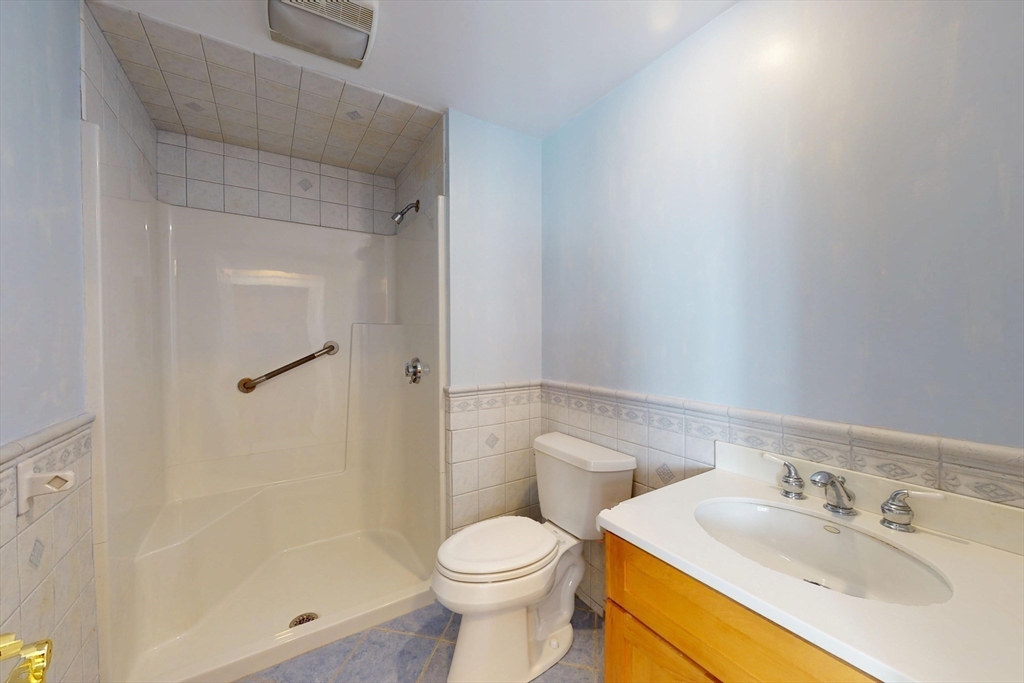 18 Faneuil Road, Unit 18 Waltham, MA 02452 - Photo 17 of 20 a white toilet sitting next to a bathroom sink