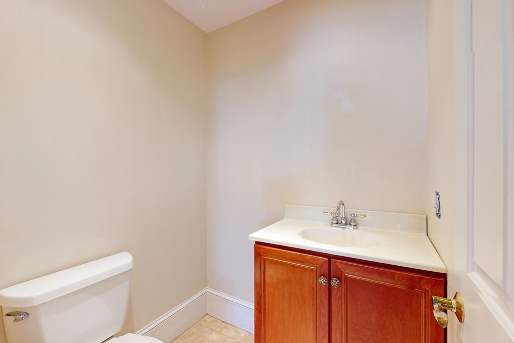18 Faneuil Road, Unit 18 Waltham, MA 02452 - Photo 18 of 20 a bathroom with a sink a toilet and mirror