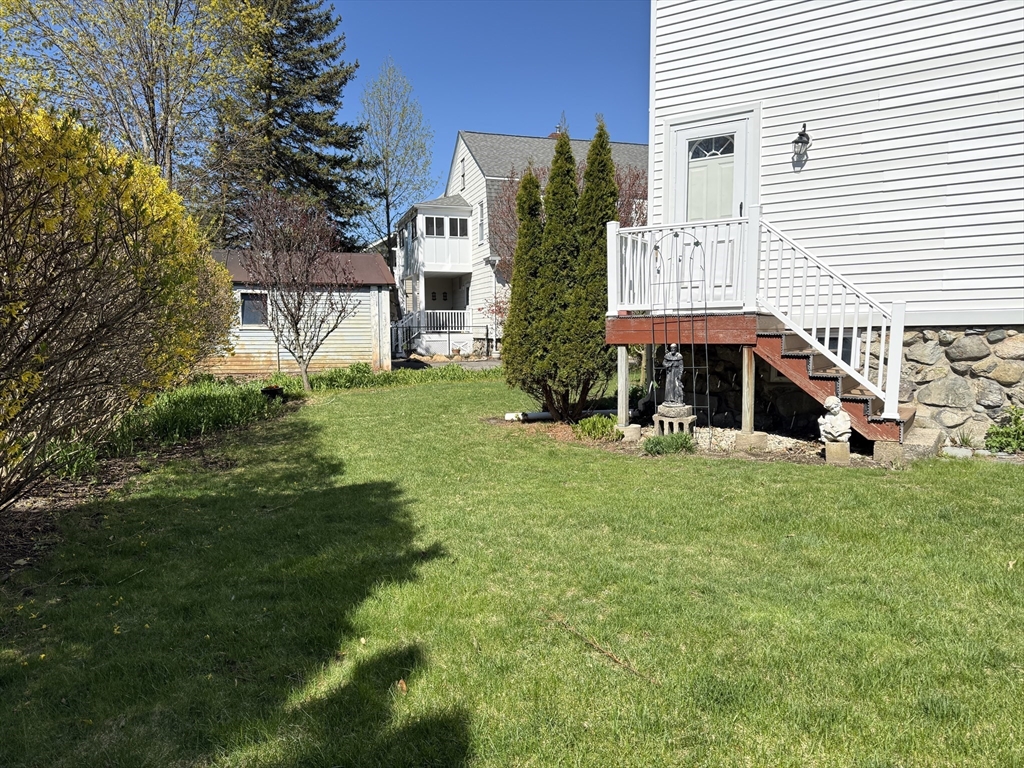 18 Faneuil Road, Unit 18 Waltham, MA 02452 - Photo 20 of 20 a view of a house with a yard