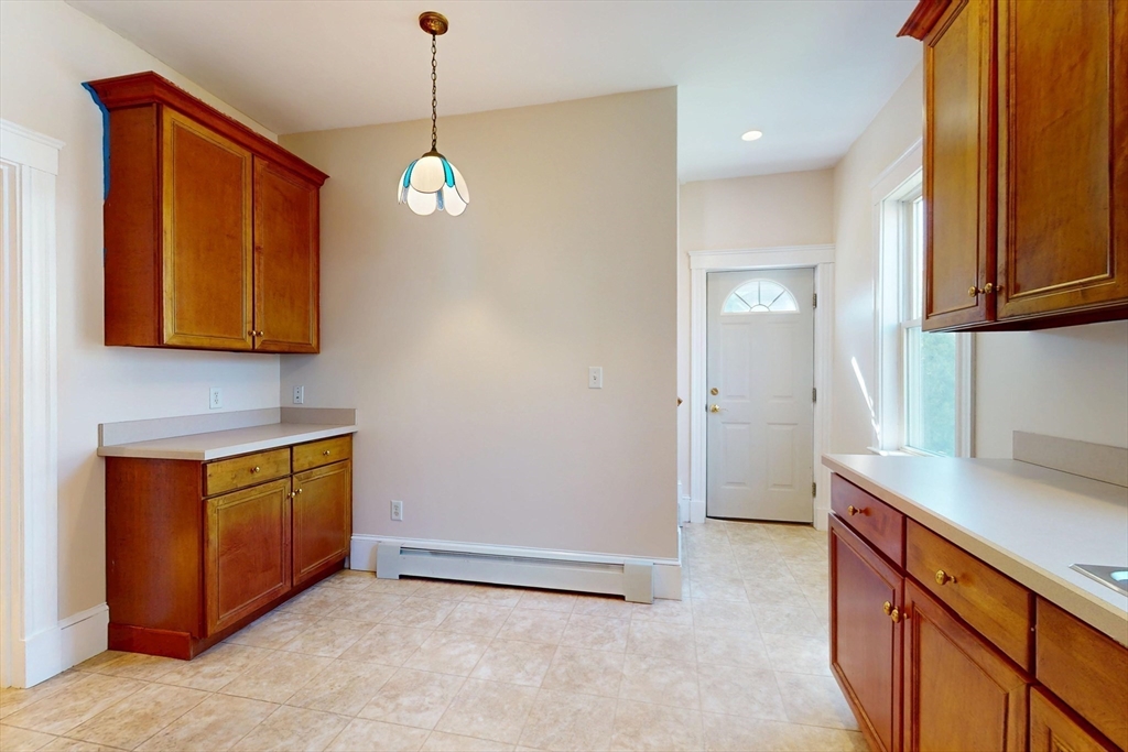 18 Faneuil Road, Unit 18 Waltham, MA 02452 - Photo 8 of 20 a kitchen with stainless steel appliances granite countertop a stove a sink and a microwave oven