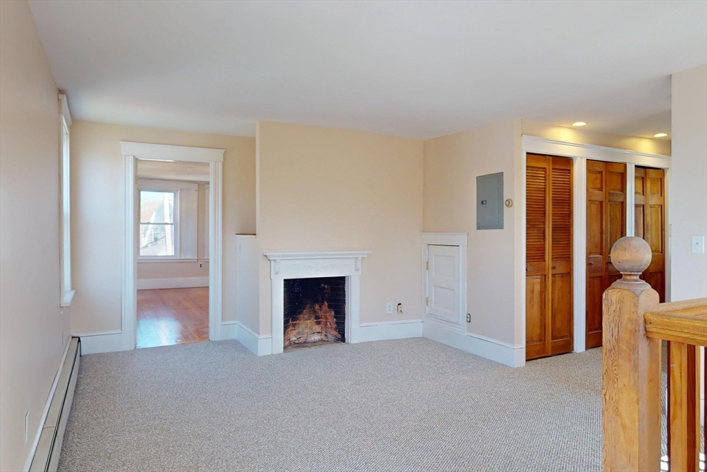 18 Faneuil Road, Unit 18 Waltham, MA 02452 - Photo 10 of 20 a view of livingroom with furniture and fireplace