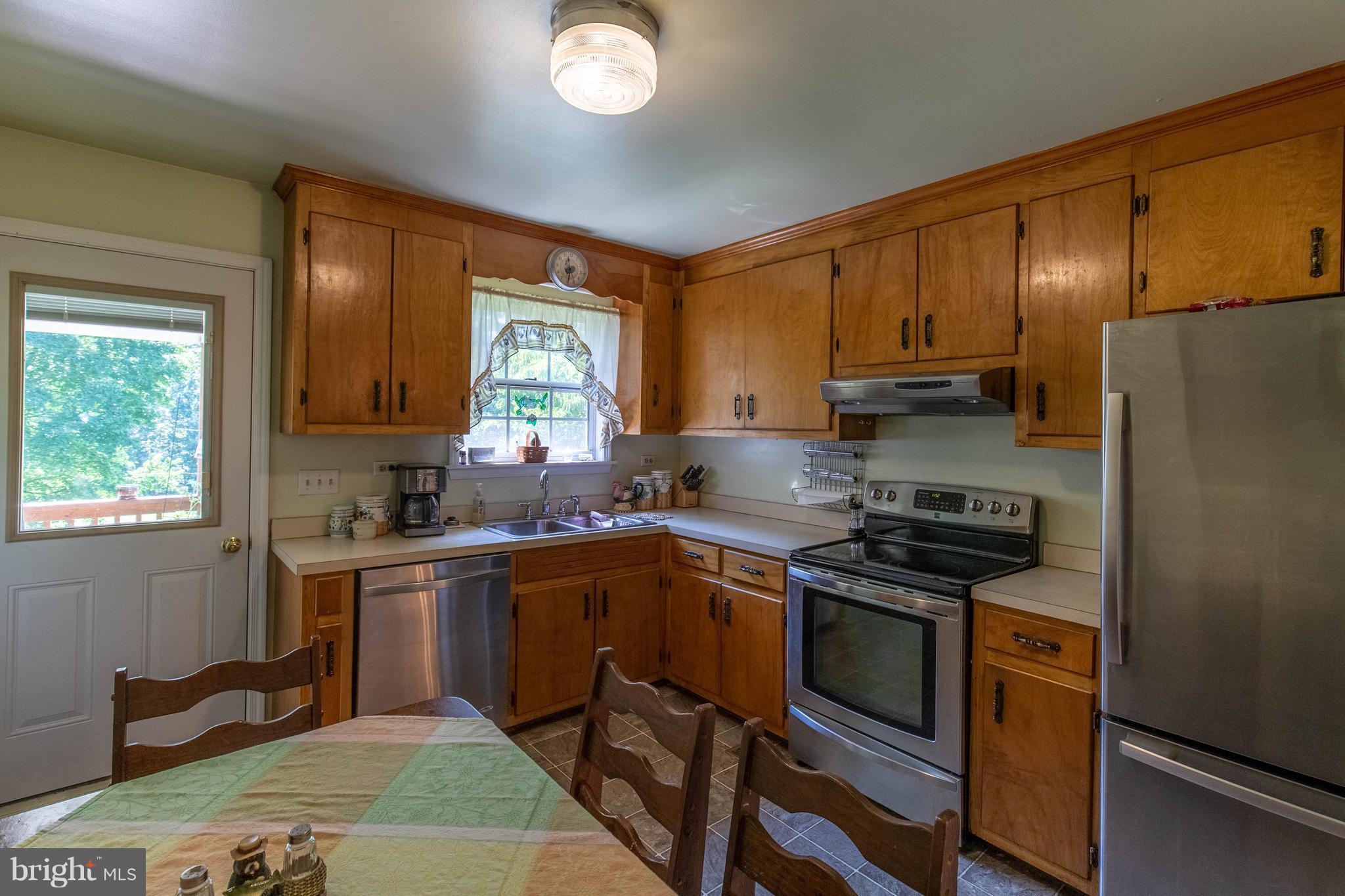 2262 Hanback Road Gordonsville, VA 22942 - Photo 13 of 24 a kitchen with a stove a sink and a refrigerator