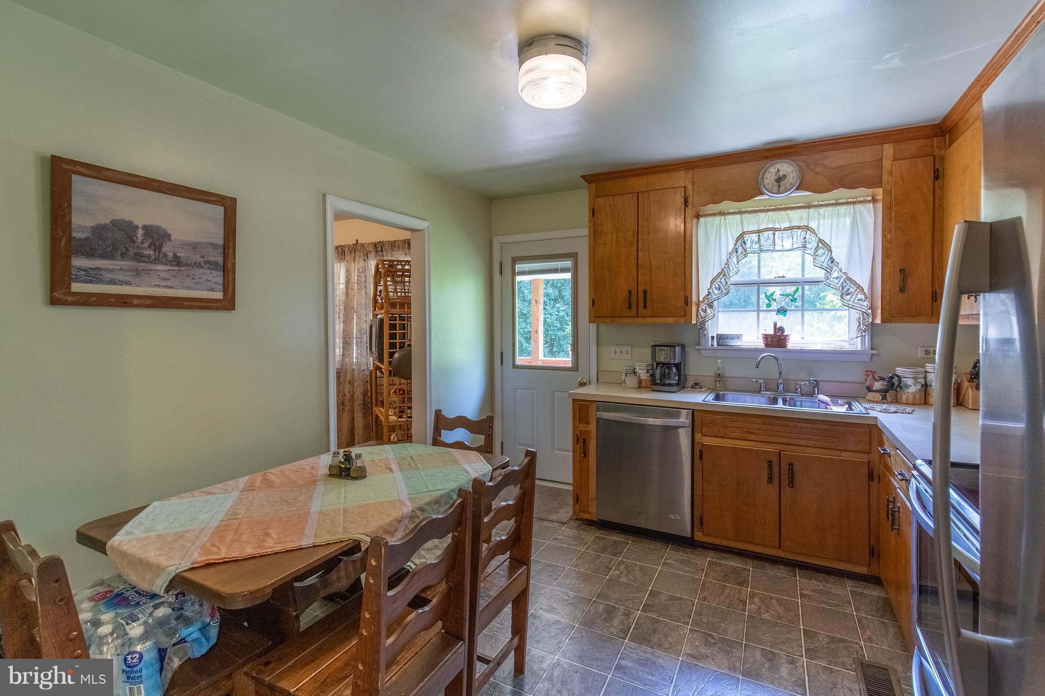 2262 Hanback Road Gordonsville, VA 22942 - Photo 14 of 24 a kitchen with a stove a sink a dining table and chairs