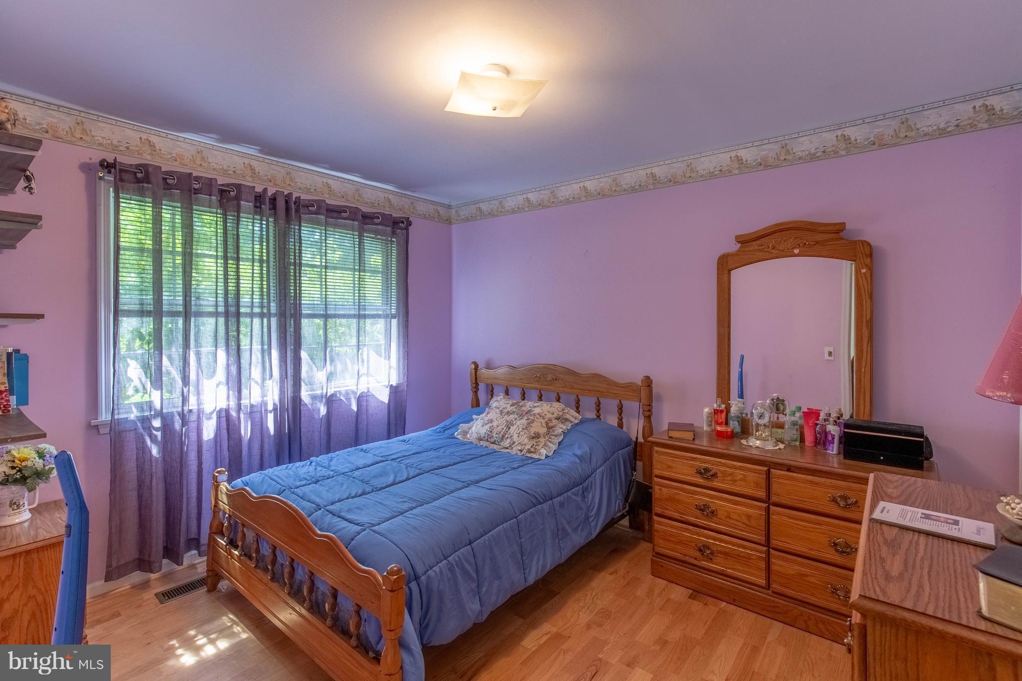 2262 Hanback Road Gordonsville, VA 22942 - Photo 15 of 24 a bedroom with a bed and large windows
