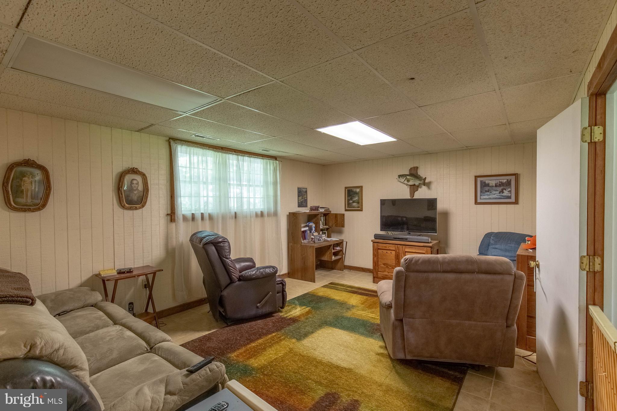 2262 Hanback Road Gordonsville, VA 22942 - Photo 18 of 24 a living room with furniture a large window and a flat screen tv