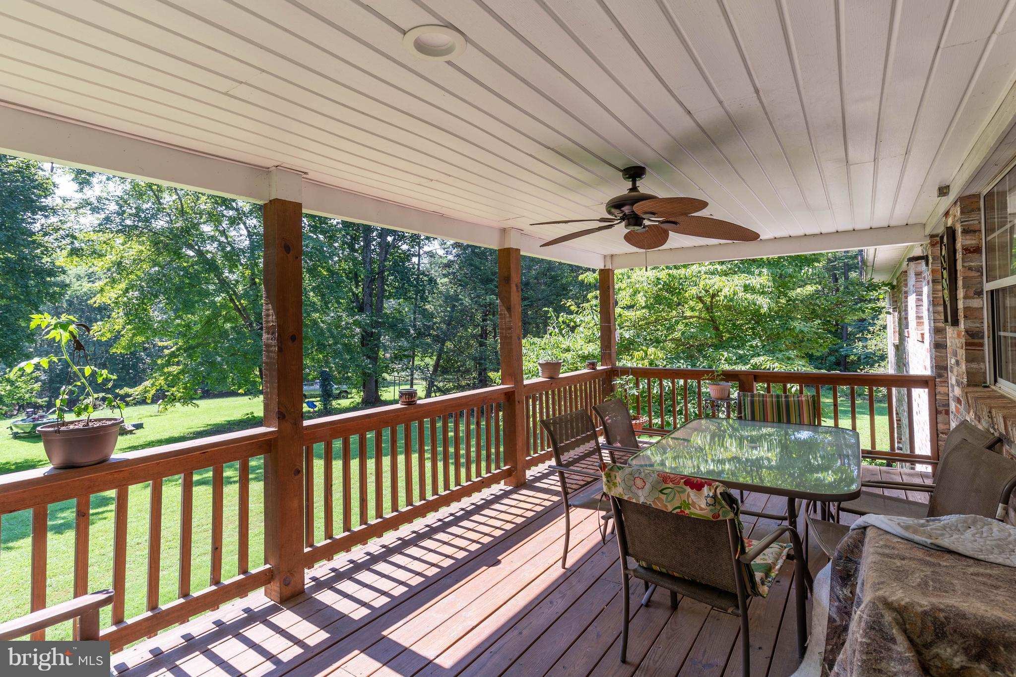 2262 Hanback Road Gordonsville, VA 22942 - Photo 6 of 24 a view of a balcony with chairs and wooden floor