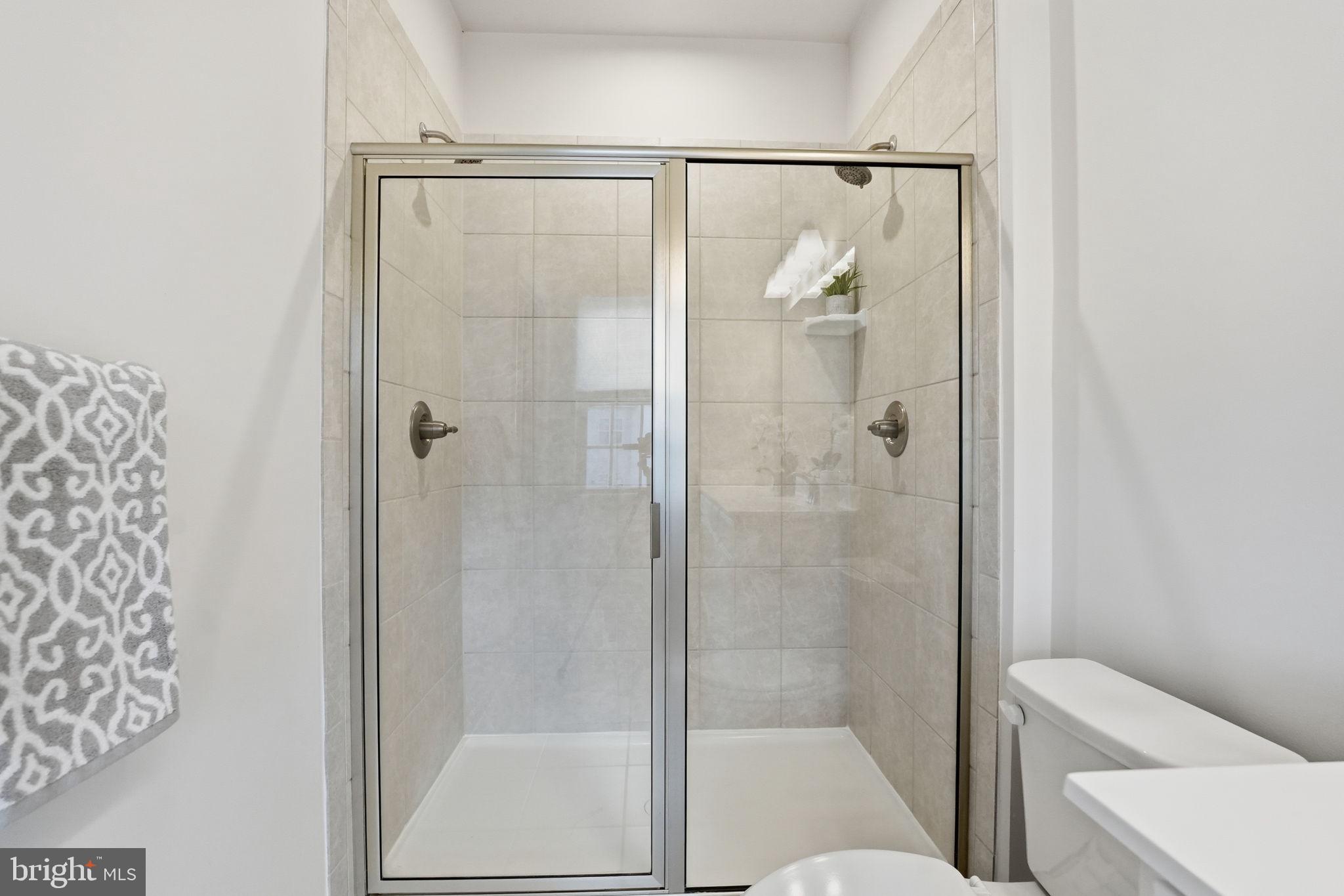 18179 Red Mulberry Road Dumfries, VA 22026 - Photo 14 of 58 a bathroom with a shower and toilet