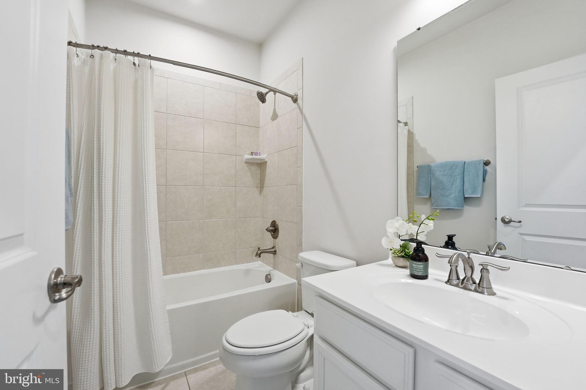 18179 Red Mulberry Road Dumfries, VA 22026 - Photo 16 of 58 a bathroom with a sink toilet and shower