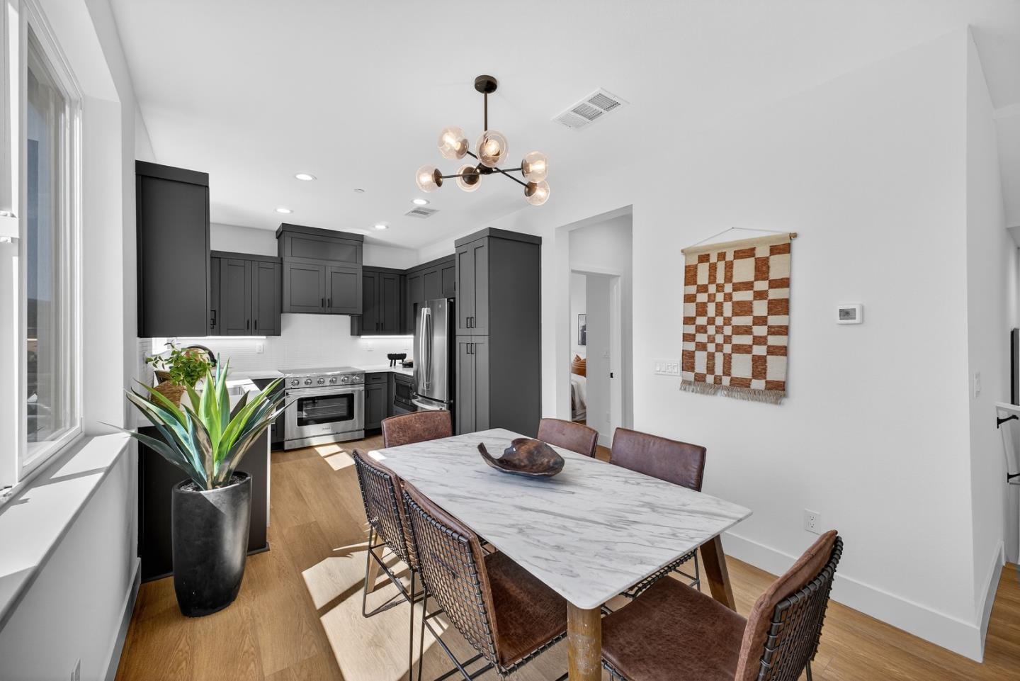 955 Woodside Road Redwood City, CA 94061 - Photo 21 of 46 a view of a dining room with furniture and wooden floor