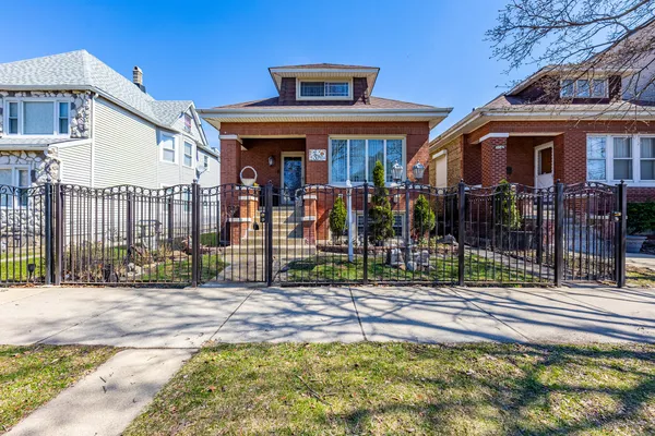 a view of a house with wooden floor and a fence