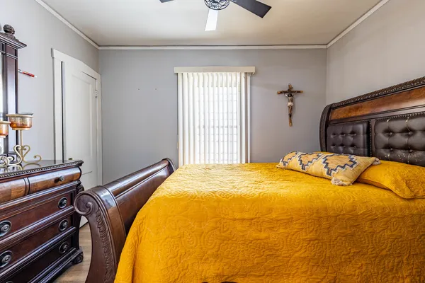 a bed sitting in a bedroom and table